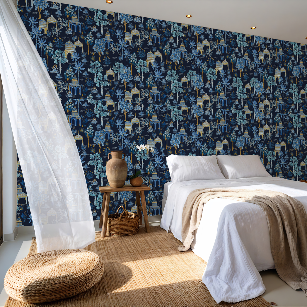 Dark blue tropical jungle wallpaper with gold details in a modern bedroom with wooden furniture and neutral decor