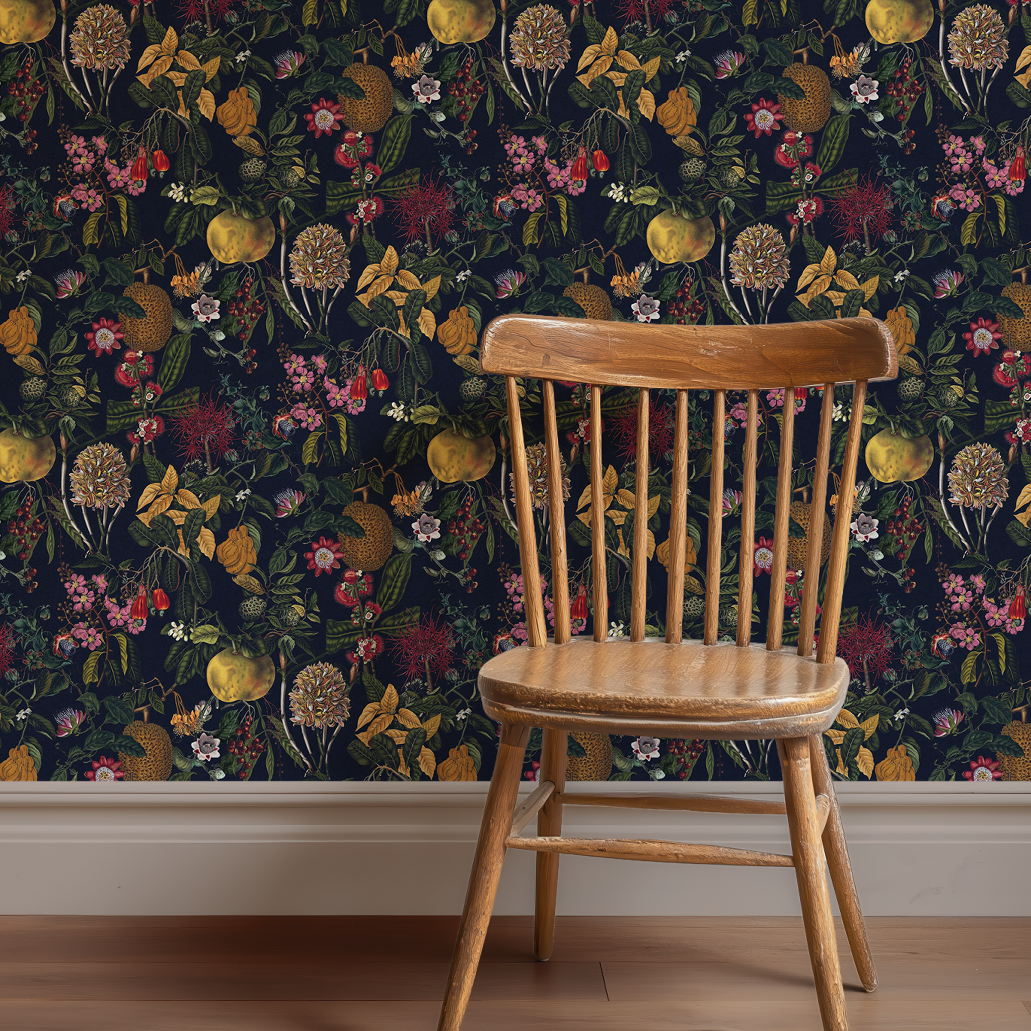 moody botanical wallpaper featuring fruits and foliage on a wall with a chair in front