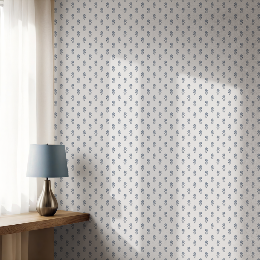 Blue poppy pattern wallpaper on a light background with wooden console table, lamp, and soft natural light