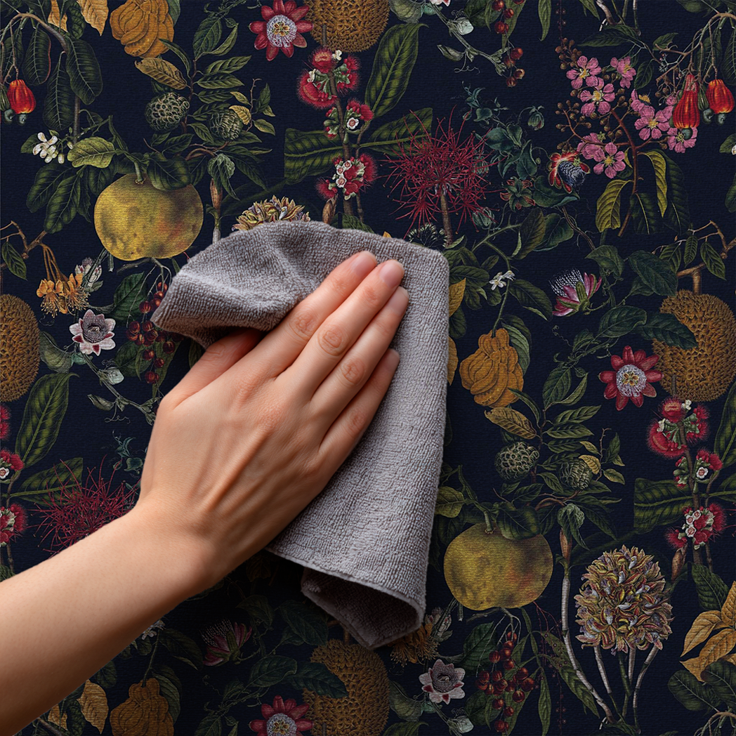 Smoothing and trimming wallpaper edges – hands using a tool to finish wallpaper installation neatly