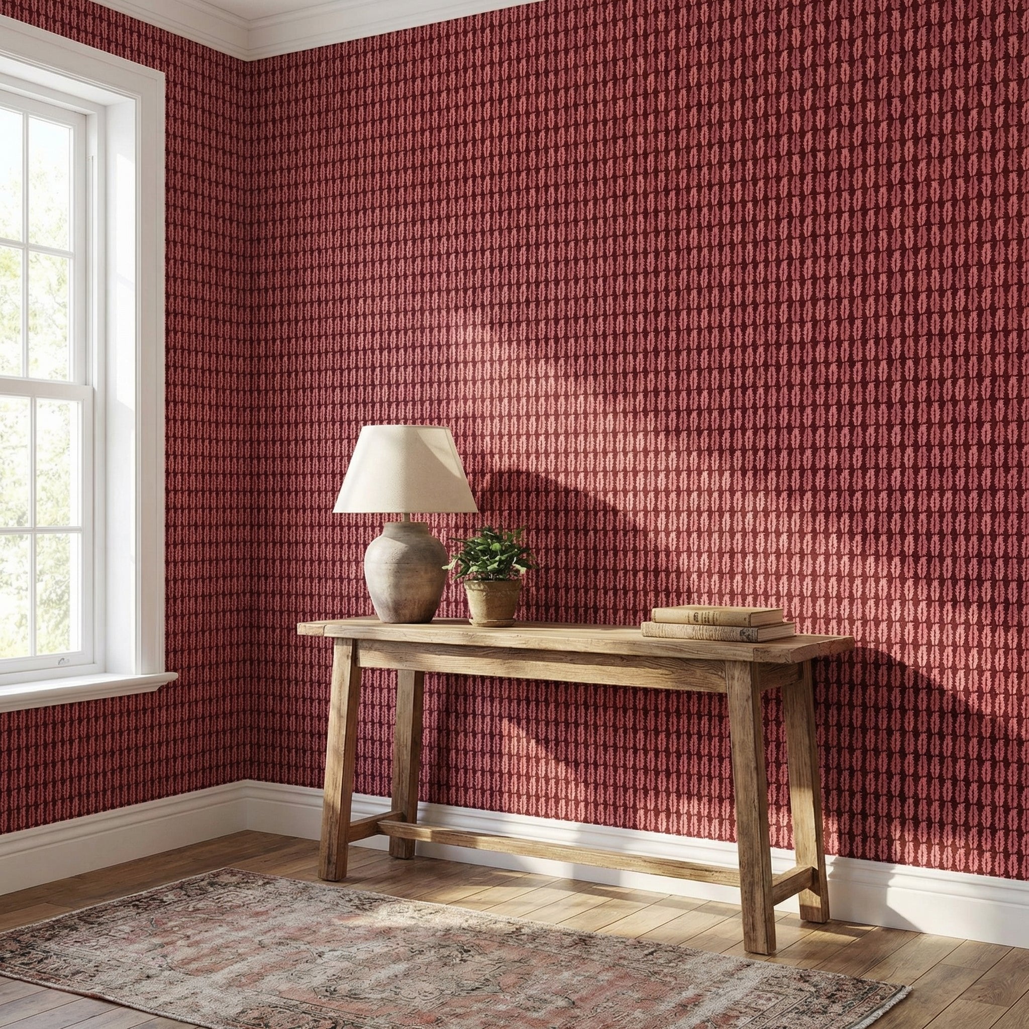 Room with red patterned wallpaper, wooden console table, and lamp.