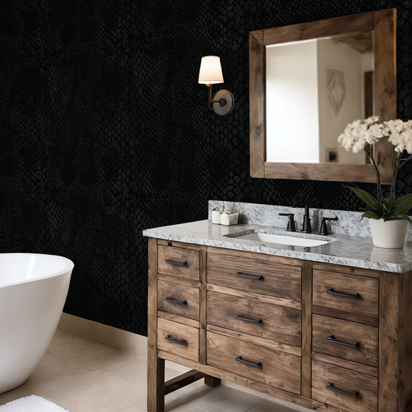 Black snakeskin wallpaper creating a moody bathroom with freestanding tub, wood vanity, and soft lighting