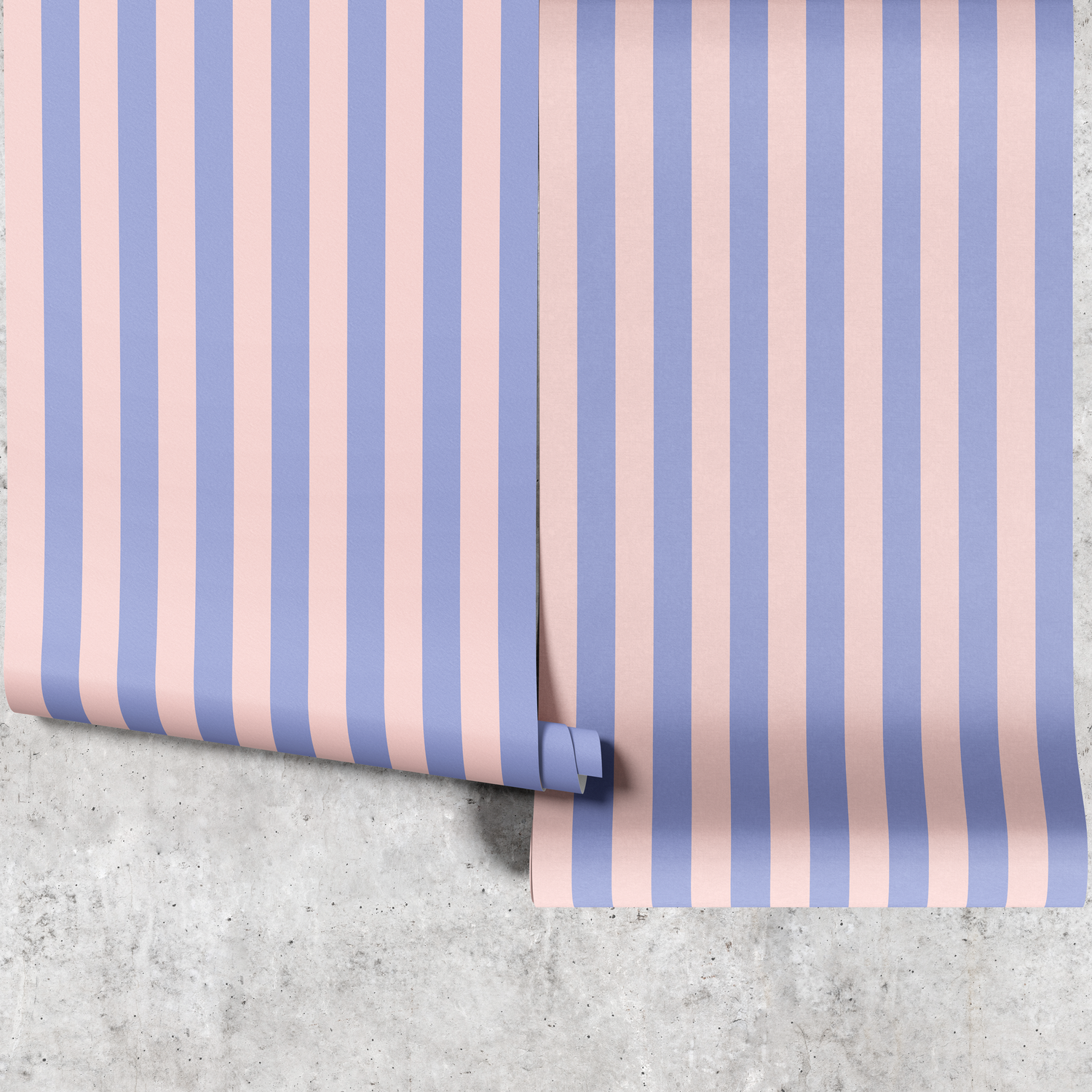 Two panels of blue and pink thin stripe wallpaper hanging against a concrete wall
