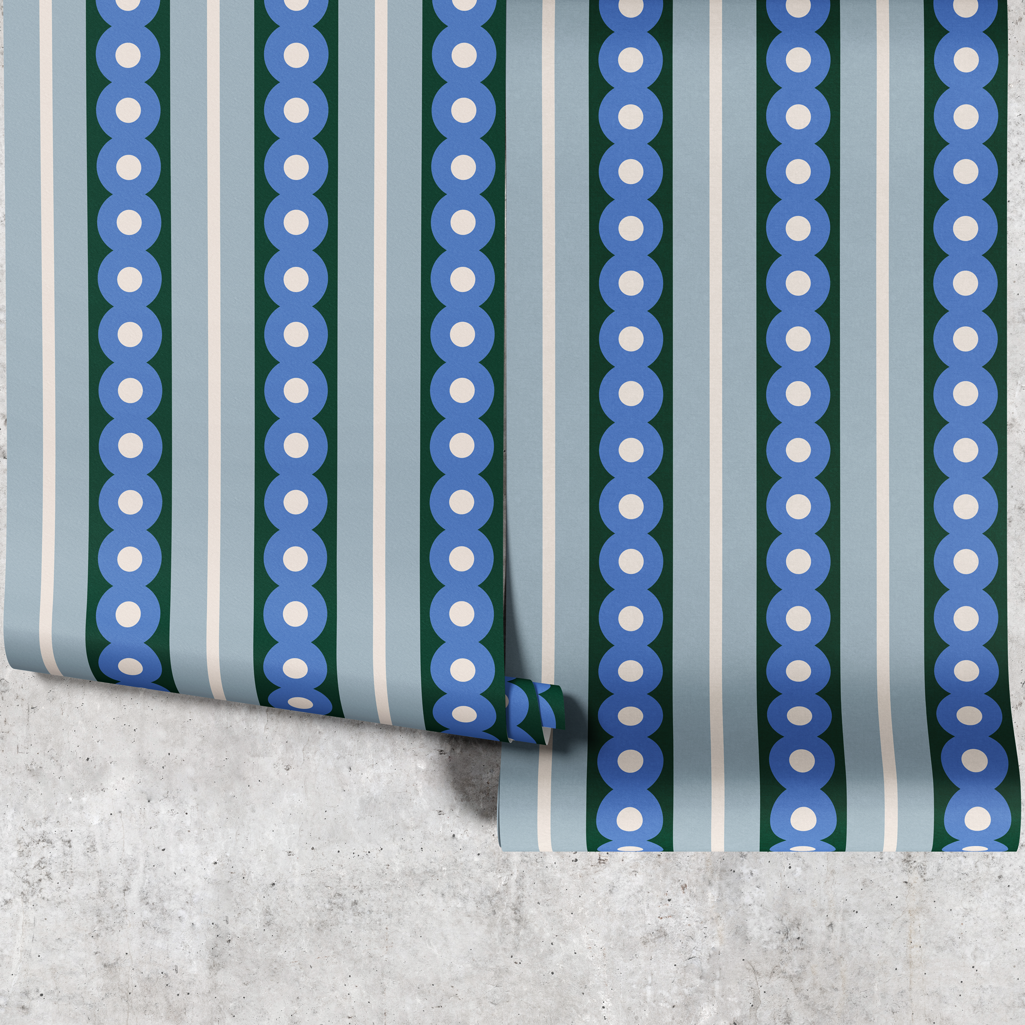 Two panels of blue circles wide stripe wallpaper hanging against a concrete wall
