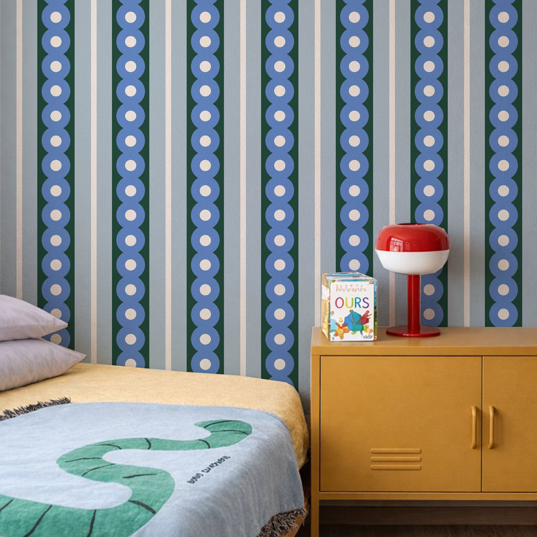 Children's room with patterned wallpaper, yellow cabinet, and colorful decor.