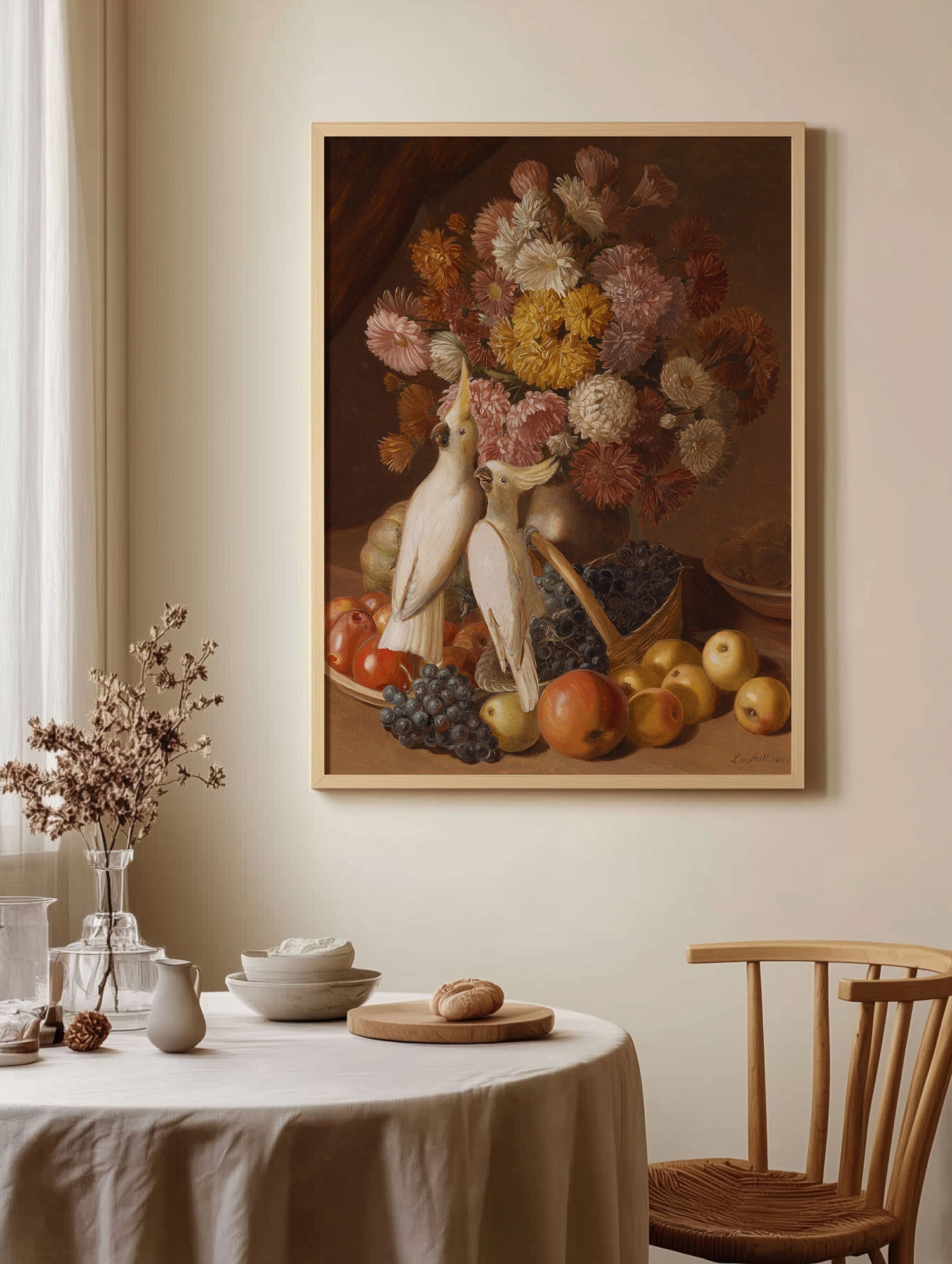 A small kitchen table and chair next to a window with a vintage artwork on the wall