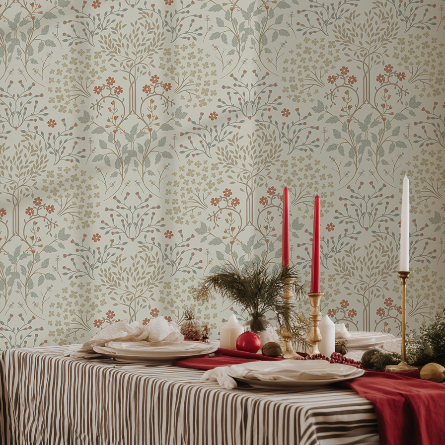 Decorative table setting with candles and plates against a patterned wallpaper.