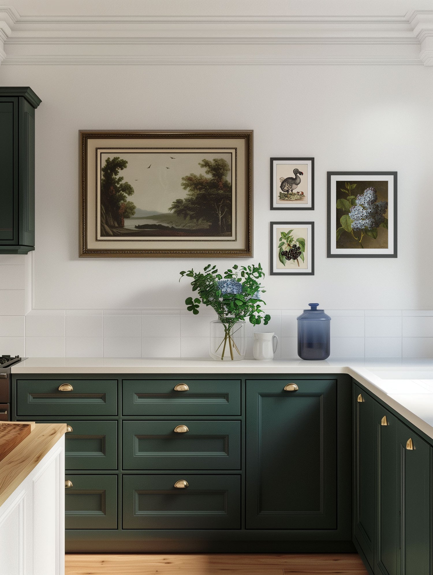 A traditional style kitchen with green cabinets and a gallery of art on the wall