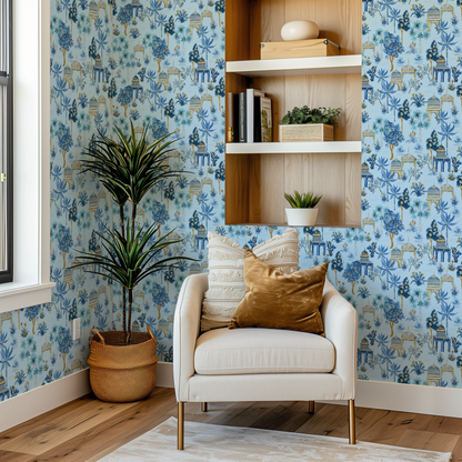 A corner of a hallway with modern white chair and light blue Bali Jungle wallpaper