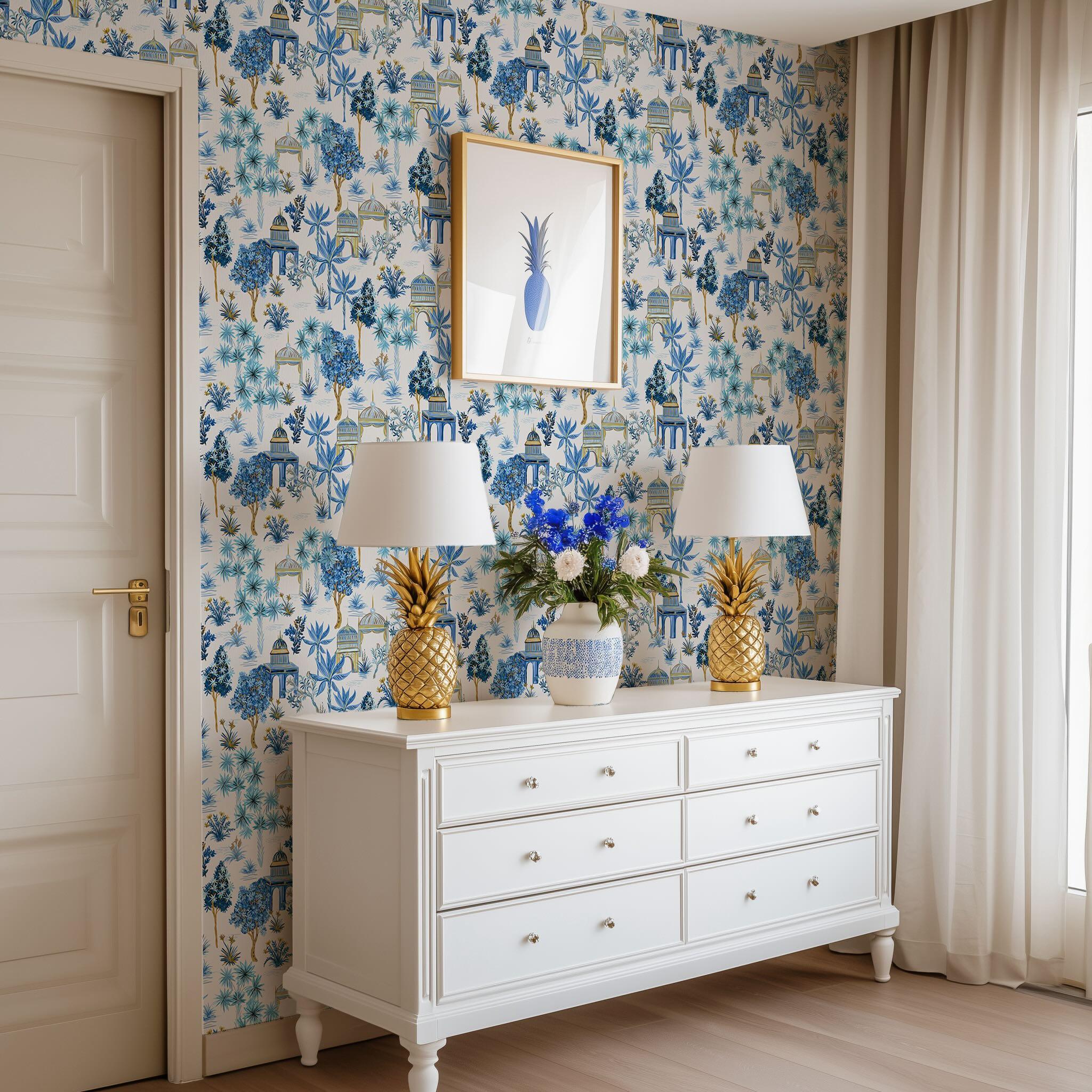 Room with blue botanical wallpaper after installation – bright dresser scene with gold accents and floral decor