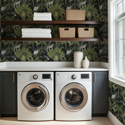 A farmhoiuse style laundry room with dark gray cabinets and walut wood shelves, and dark gray Rainforest Animals wallpaper 