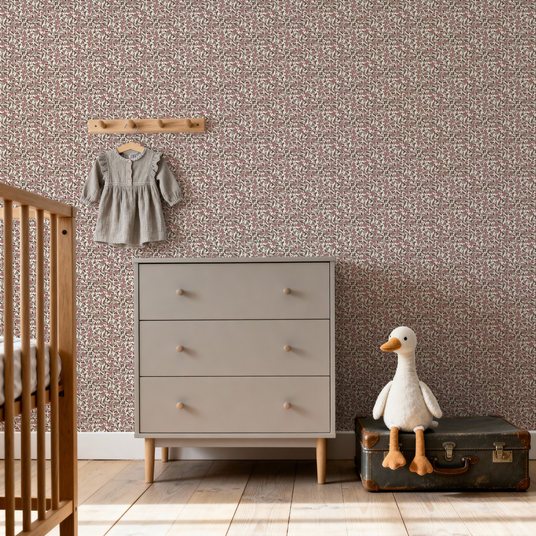 Nursery room with a dresser, crib, and decorative items on a patterned wall.