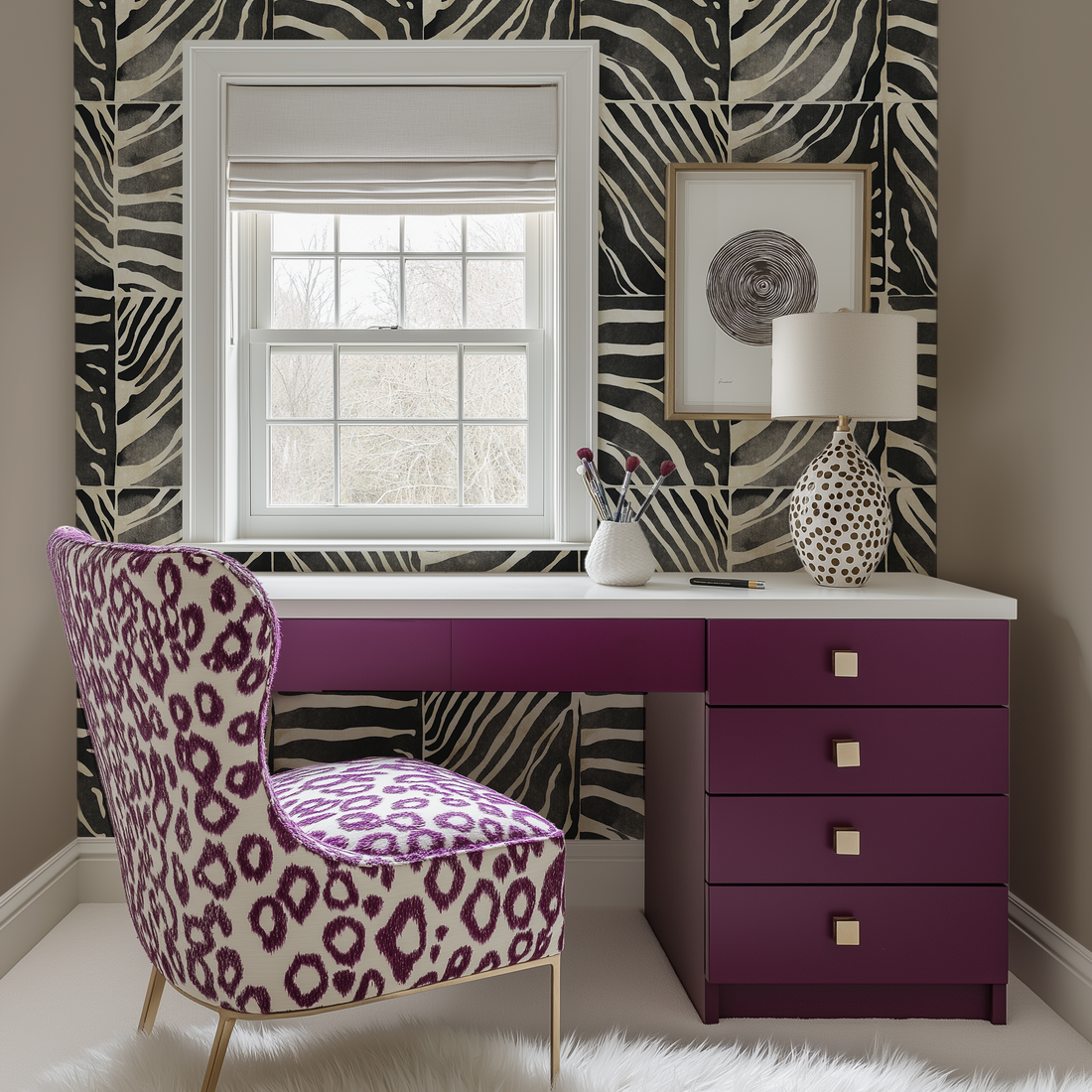 A plum vanity table in front of a window with an abstract leopard print chair. There is a block zebra print wallpaper on the wall.