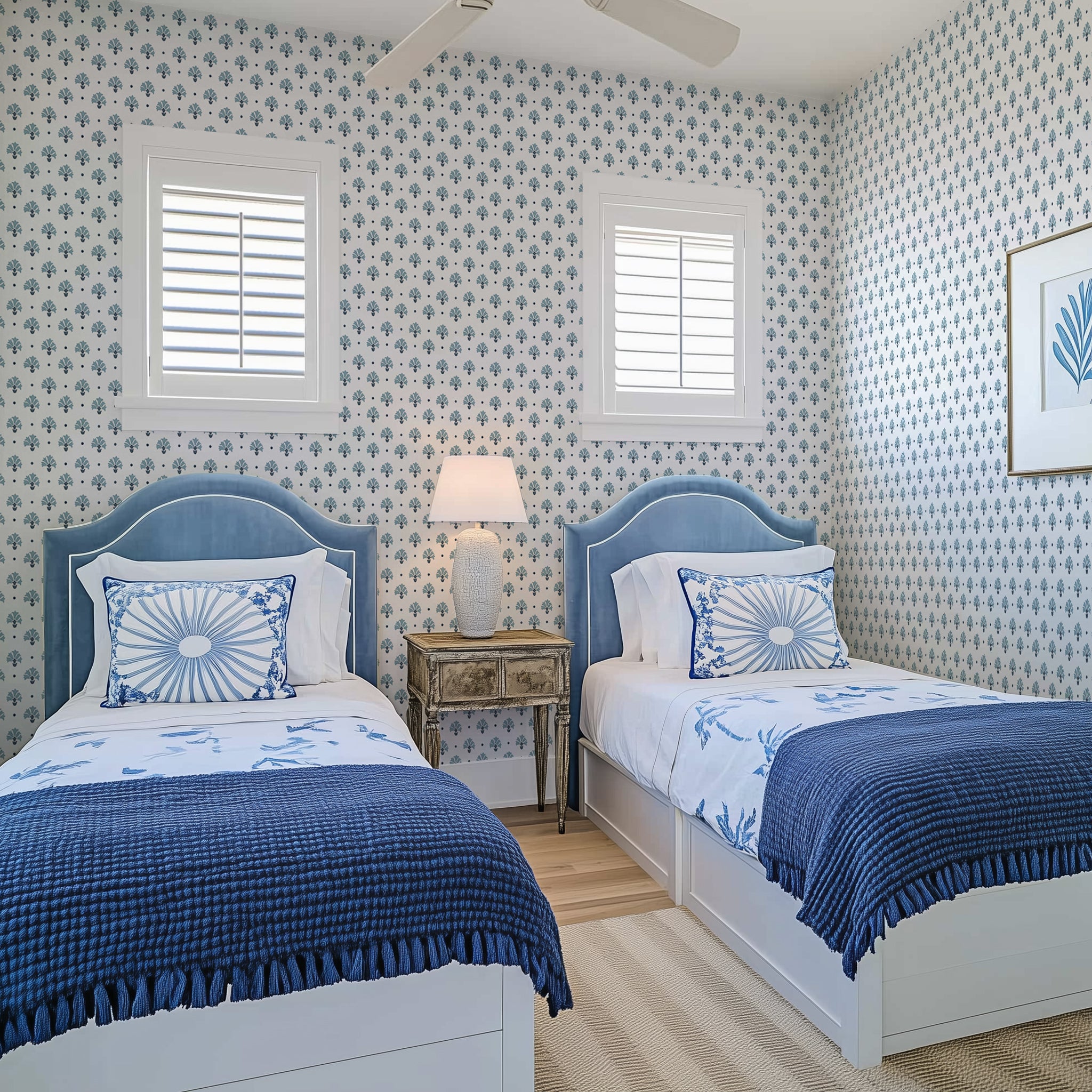 A coastal inspired twin bedroom with blue and white colors and ditsy floral wallpaper