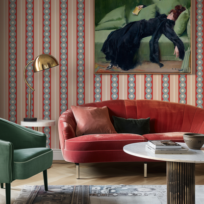 An eclectic living room with midcentury wide stripe wallpaper and large art piece